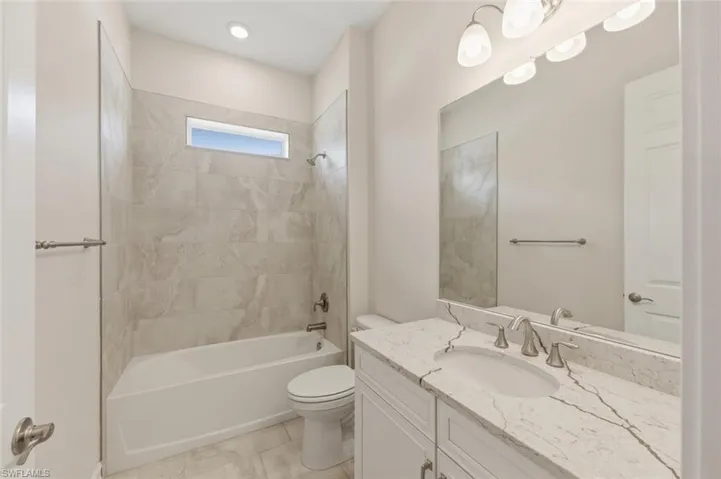 Bathroom featuring vanity and shower / bathtub combination