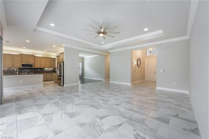 Upgraded tile in Great Room with Crown Molding and Tray Ceilings
