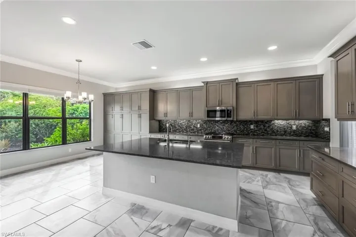 Upgraded Kitchen Cabinetry, Quartz Counters and Tile Backsplash