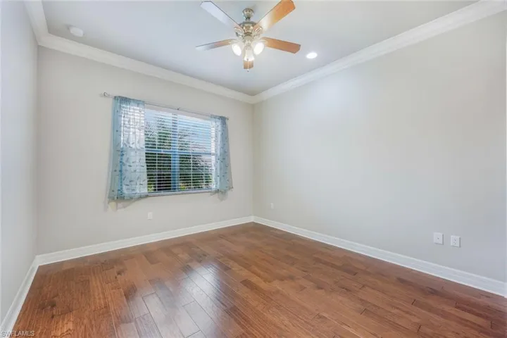 Secondary bedroom #3 with Wood Flooring and Crown Molding