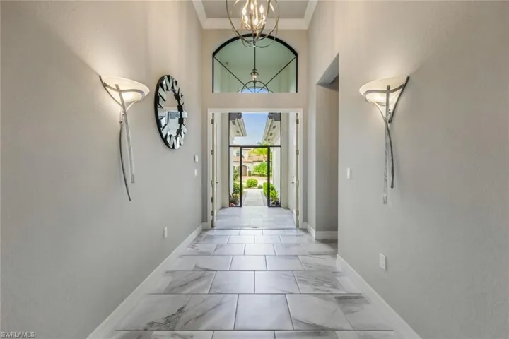Elegant Foyer with 18 Foot Ceiling, Crown Molding and Neutral colors