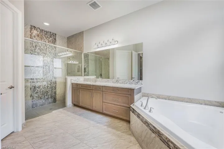 Master Bathroom Shower with Upgraded and Extended to Ceiling Porcelain and Glass tile