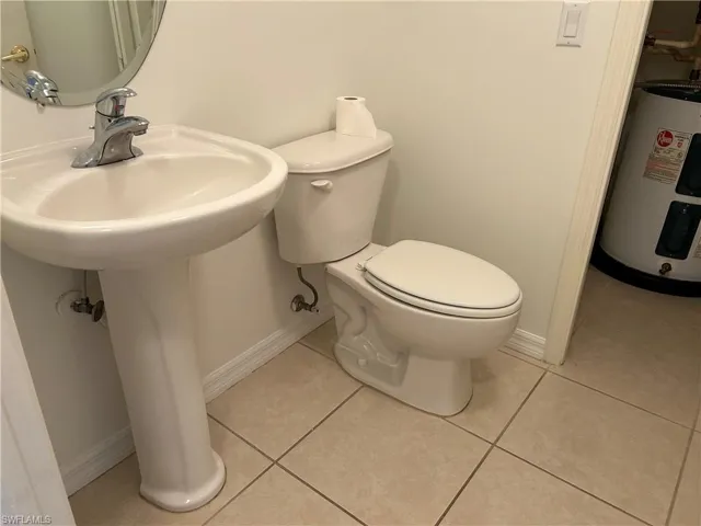 Bathroom featuring water heater and tile patterned floors