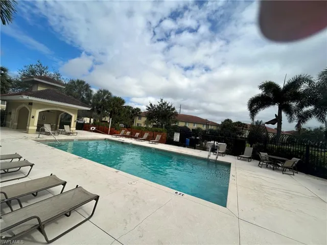 Community pool with a patio