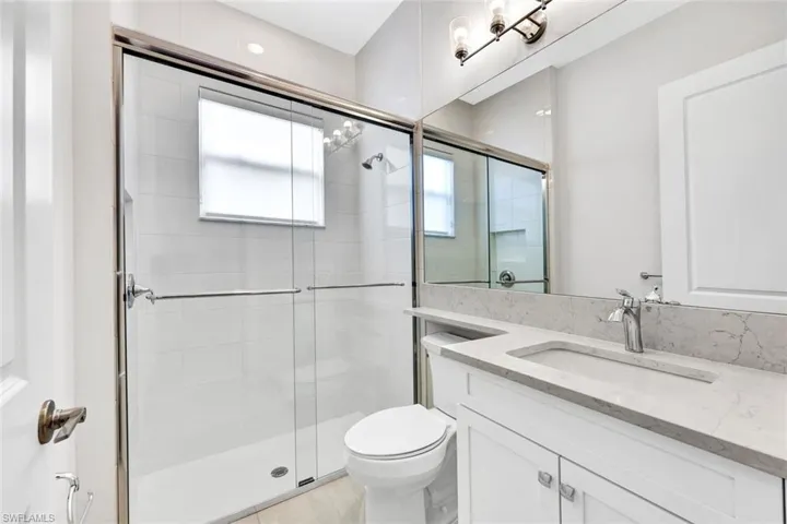 Second Floor Bathroom featuring vanity, toilet, and an enclosed shower