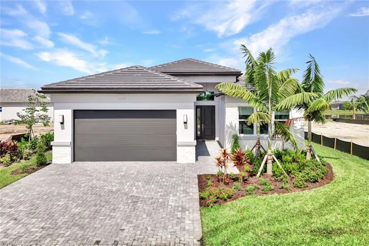 View of front of property featuring a front yard and a 2 car garage