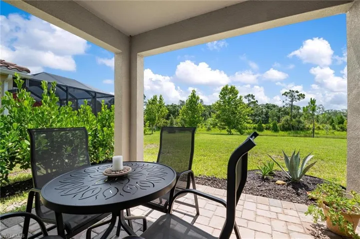View of patio featuring a lanai