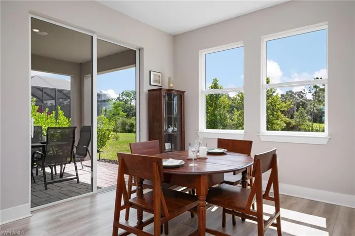 Dining area with a wealth of natural light and light wood-type flooring
