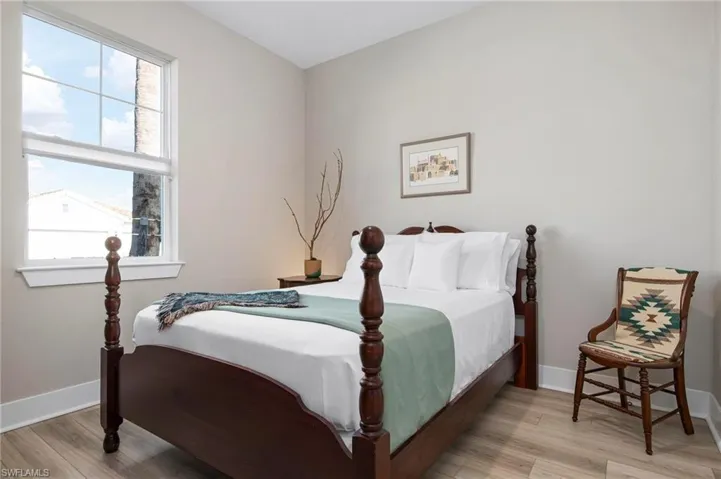 Bedroom with multiple windows and light wood-type flooring