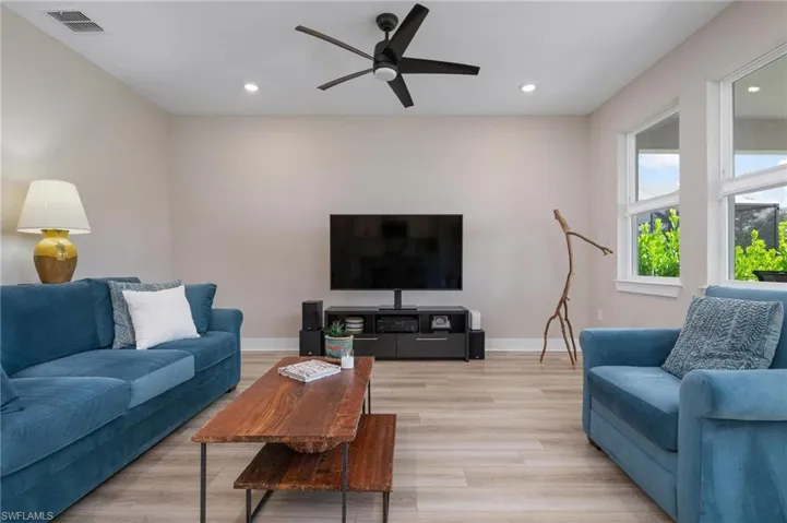 Living room featuring light hardwood / wood-style floors and ceiling fan
