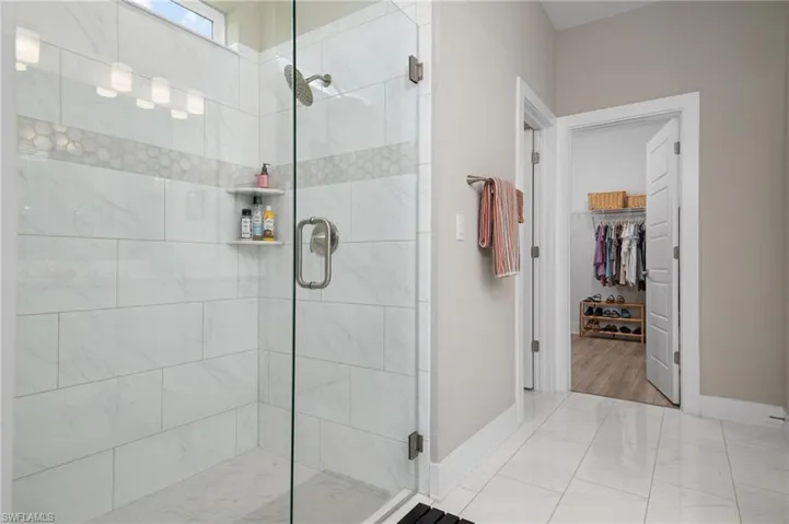 Bathroom with an enclosed shower and wood-type flooring