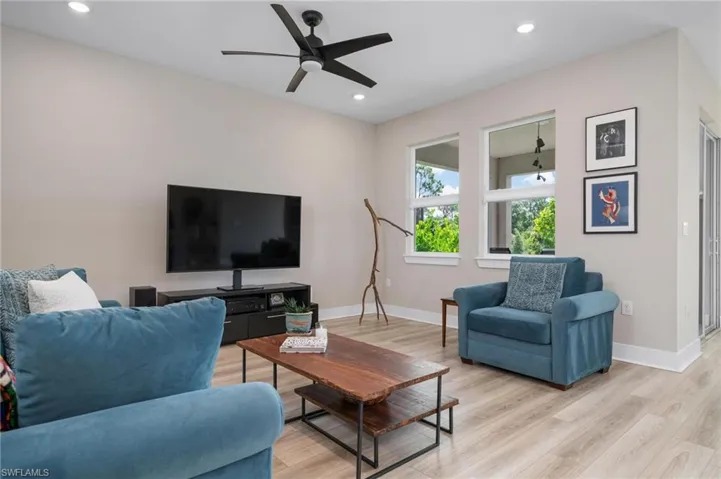 Living room featuring ceiling fan and light wood-type flooring