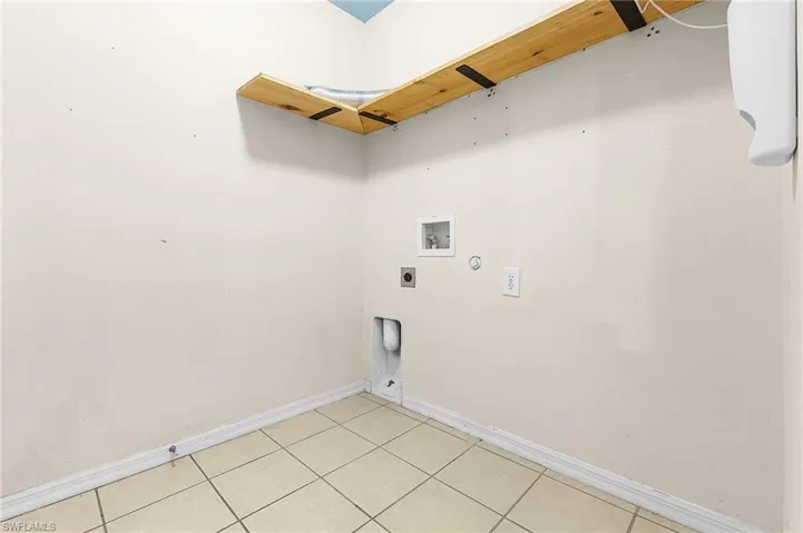Laundry room featuring gas dryer hookup, washer hookup, electric dryer hookup, and light tile patterned flooring