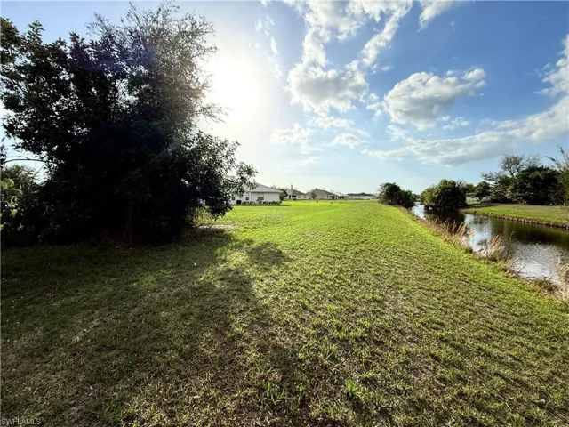 View of green lawn featuring a water view