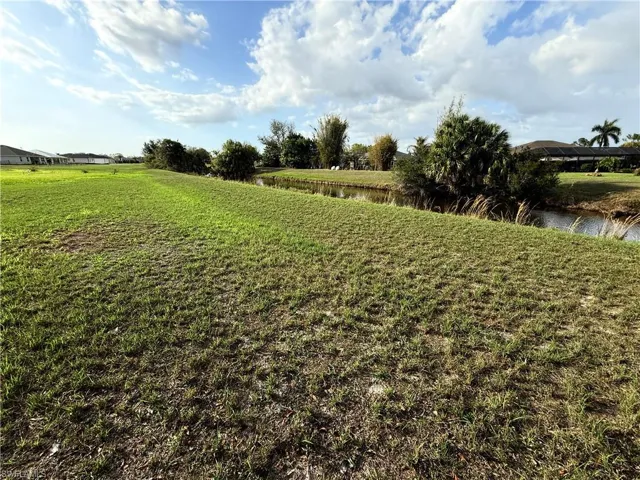 View of grassy yard with a water view