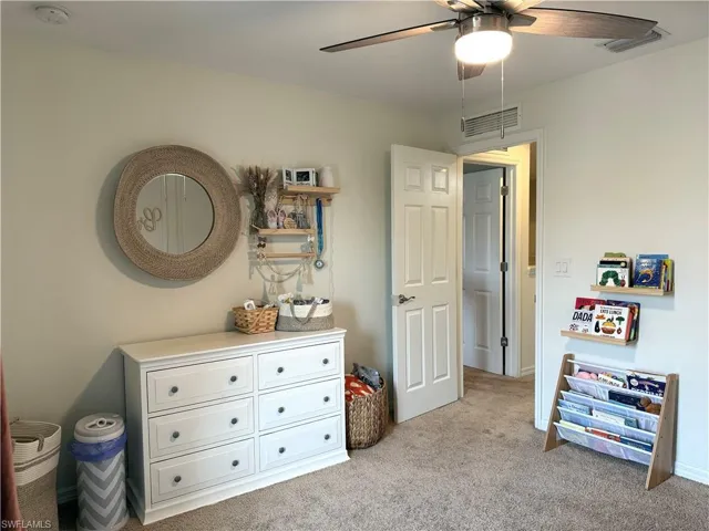 Bedroom with light carpet and ceiling fan