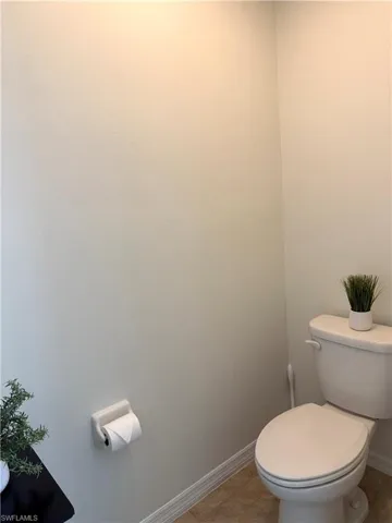 Bathroom with toilet and tile patterned flooring
