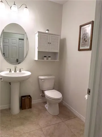 Bathroom with toilet and tile patterned flooring