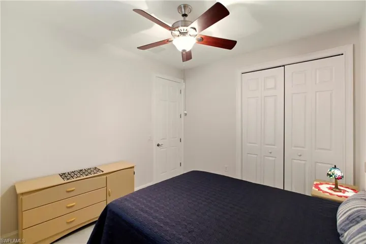 Bedroom with ceiling fan and a closet
