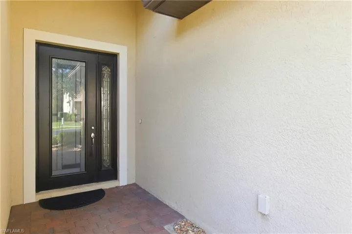 Property entrance featuring stucco siding
