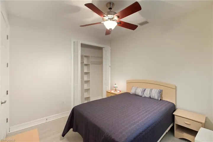 Bedroom with light wood finished floors, a closet, and ceiling fan