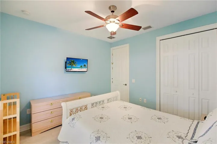 Bedroom featuring a ceiling fan and a closet