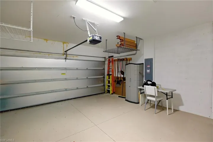 Garage with electric panel and a garage door opener