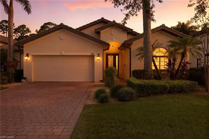 Mediterranean / spanish house featuring decorative driveway, stucco siding, an attached garage, and a front lawn