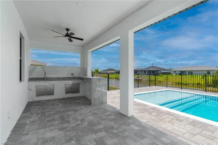 View of pool with a patio and ceiling fan