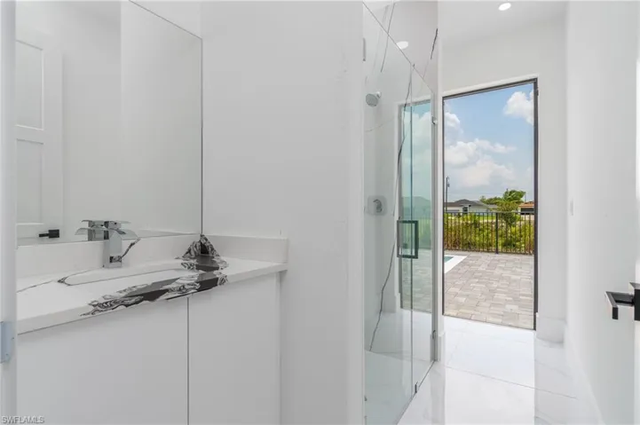Bathroom with tile floors, shower with separate bathtub, and vanity