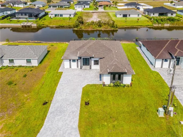 Birds eye view of property with a water view