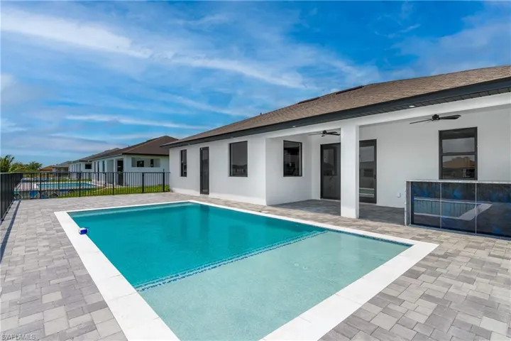 View of swimming pool with a patio area and ceiling fan