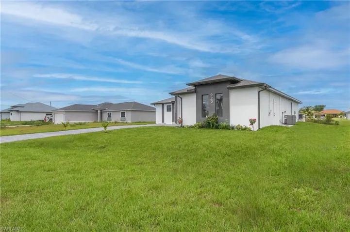 View of front of property featuring central AC and a front lawn