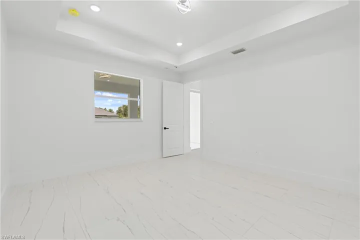 Tiled empty room with a raised ceiling