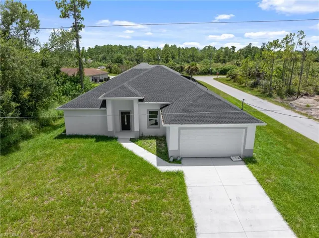 View of front of house featuring a garage and a front yard