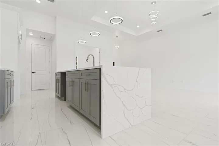 Bathroom featuring tile patterned floors and a raised ceiling