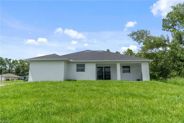 Back of property with a yard