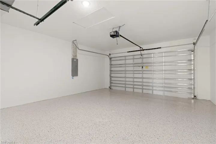 Garage with a garage door opener and electric panel