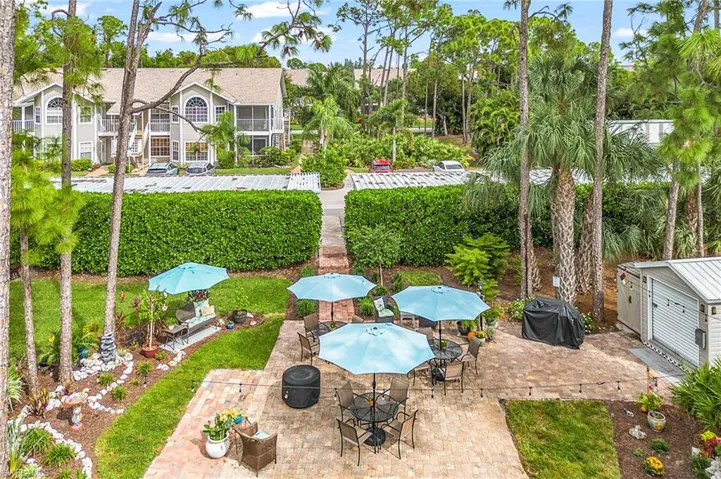 View of patio featuring area for grilling and outdoor dining area