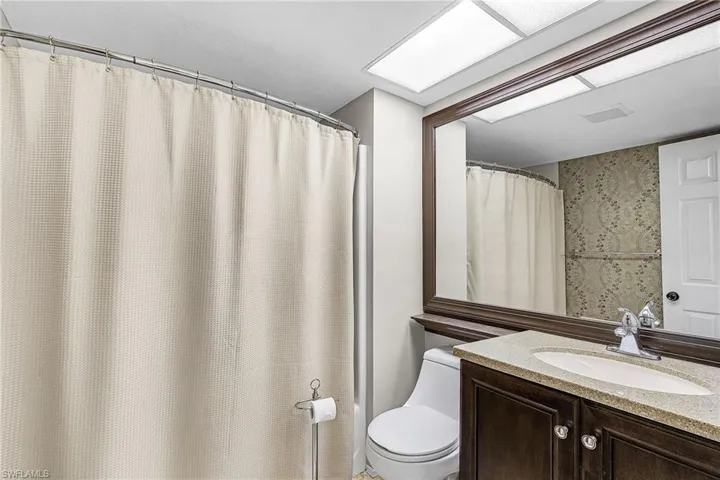 Full bathroom featuring vanity and a shower with curtain