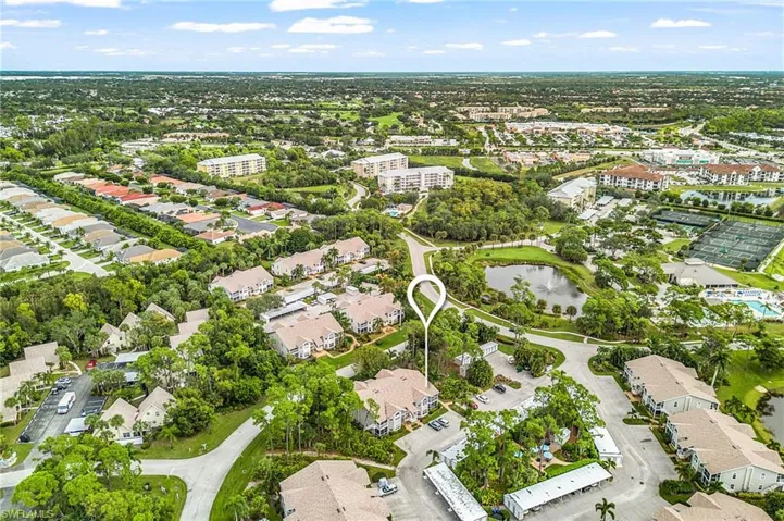 Aerial view of property and surrounding area with a nearby body of water and nearby suburban area