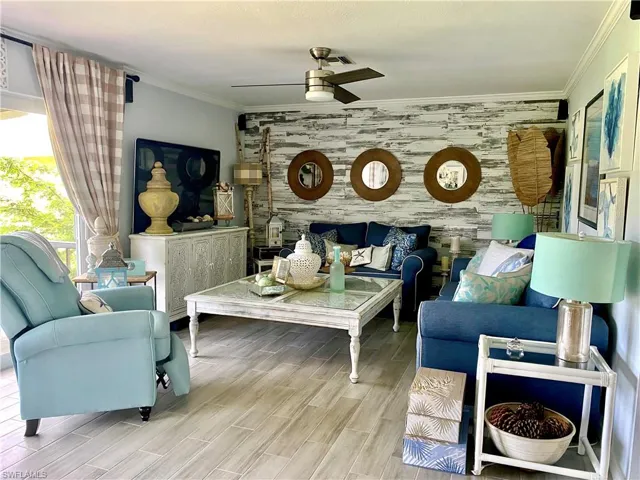 Spacious living room area with sofa, loveseat and recliner to relax and watch TV or step out to the enclosed balcony to watch the sunsets