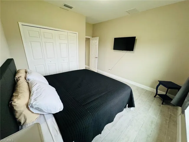 Bedroom with baseboards and a closet