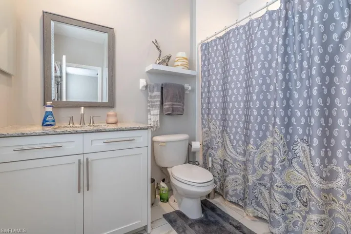 Bathroom with vanity, toilet, and tile patterned floors