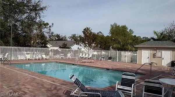 View of swimming pool featuring a patio area and an outdoor structure