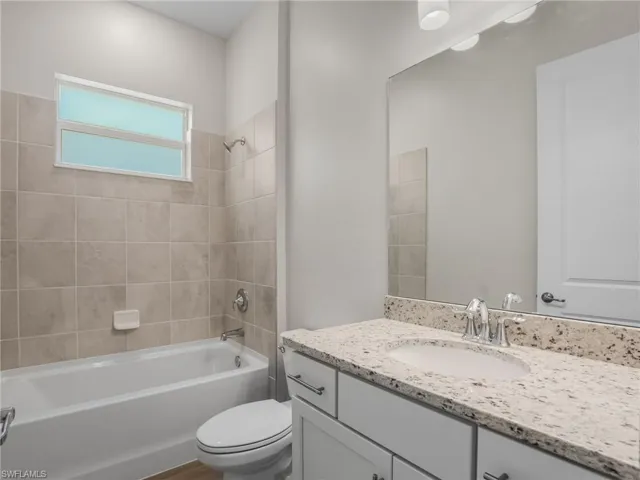 Bathroom with vanity and  tub shower combination