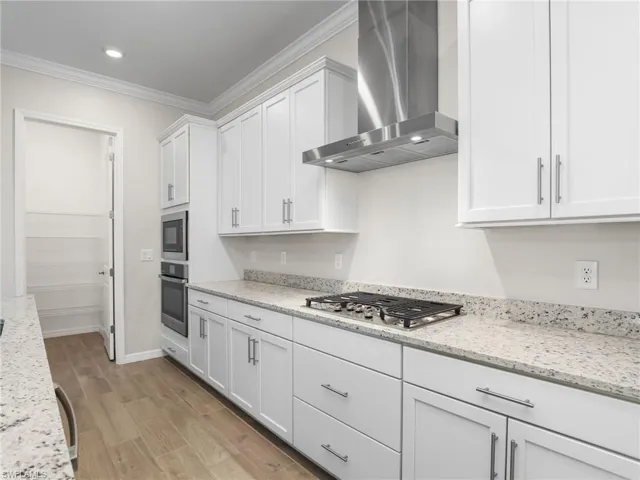 Kitchen with stainless exhaust hood