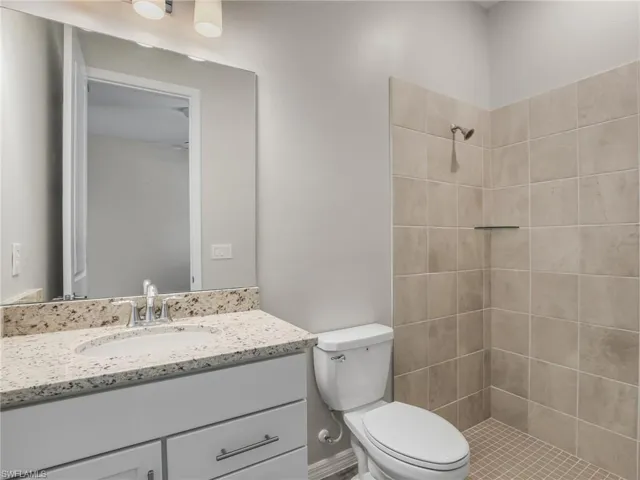Full bathroom featuring vanity and tiled shower