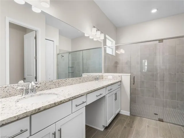 Bathroom with double vanity, and a  spacious walk-in shower