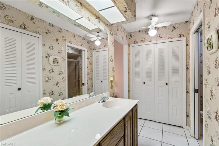 Bathroom with tile flooring, ceiling fan, and vanity